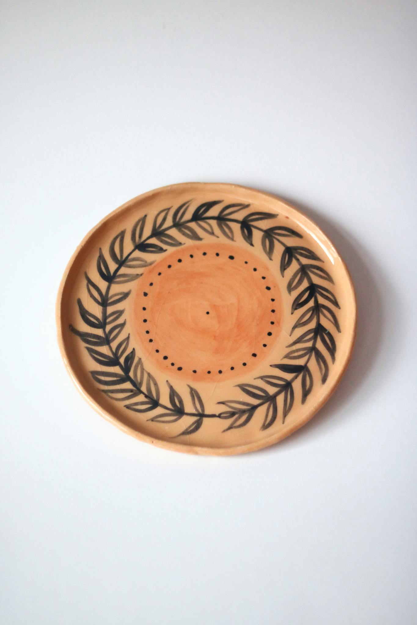A beautifully crafted ceramic plate featuring a delicate leaf design.