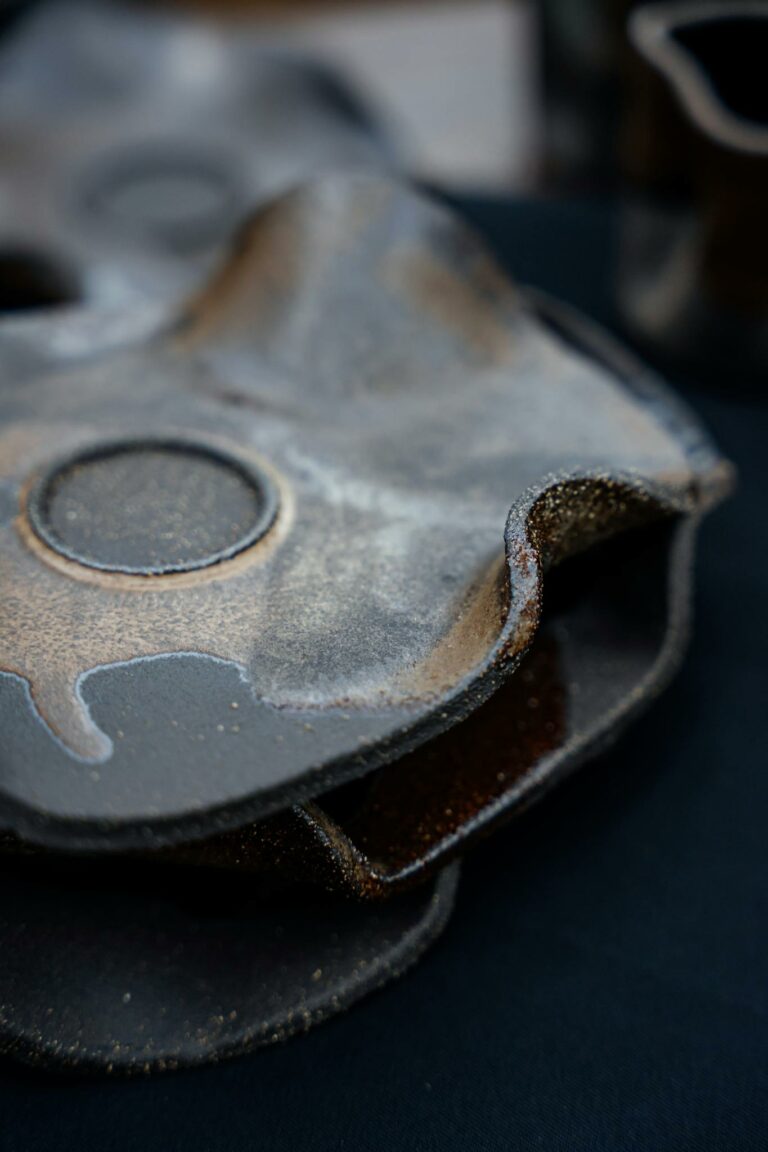 Artistic close-up of rustic handmade pottery with unique glaze finish.